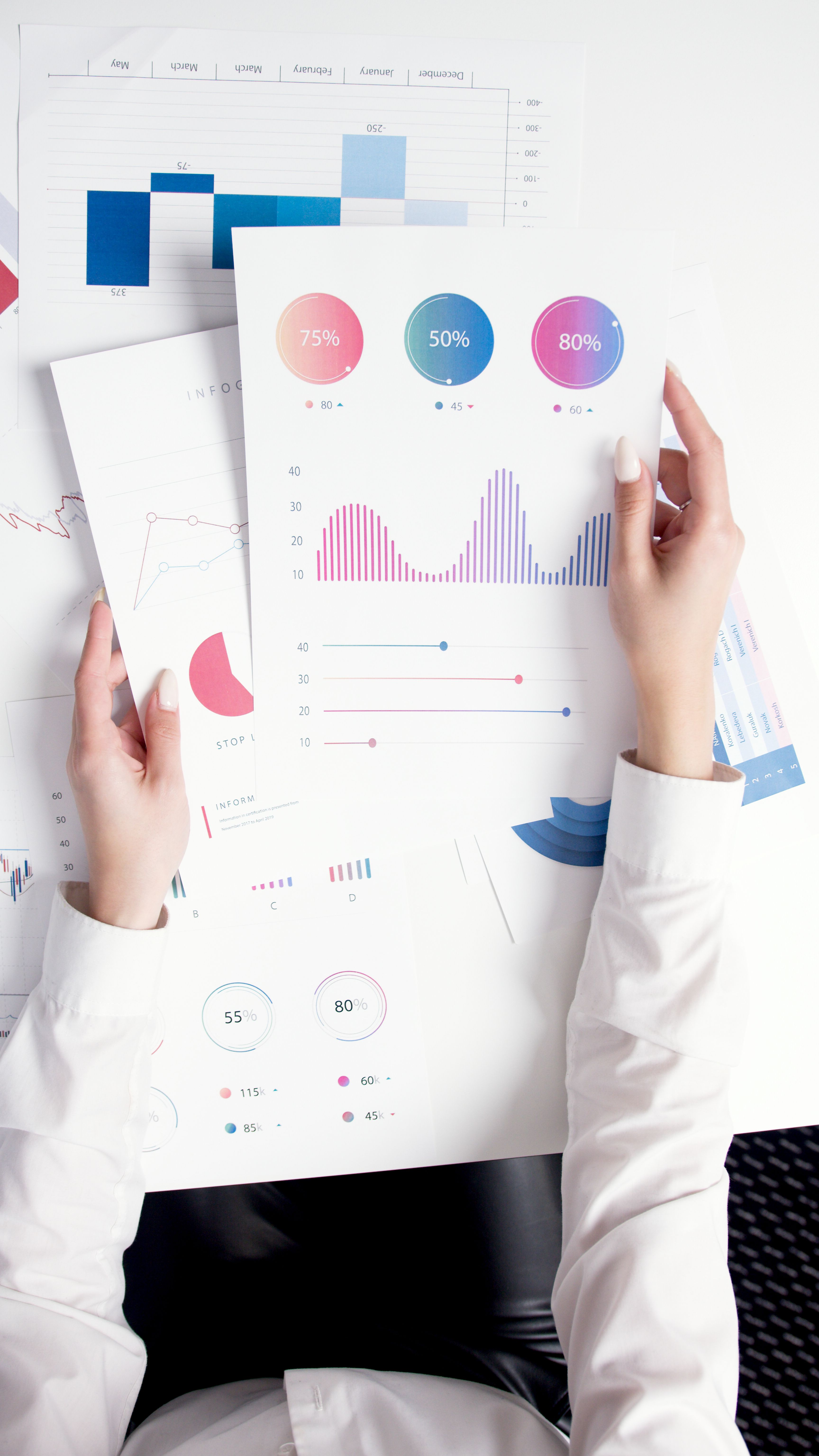 Hands holding printed quality charts and reports